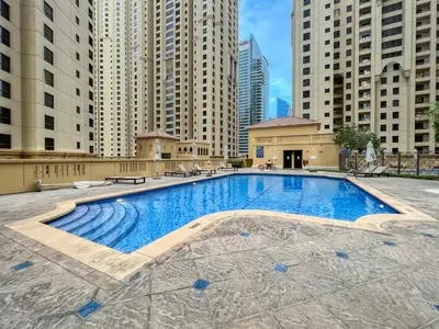 a large swimming pool in a city with tall buildings at GuestReady - Sea la Vie - Lux in JBR in Dubai