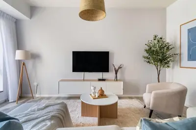 a living room with a tv and a couch and a table at GuestReady - Sea la Vie - Lux in JBR in Dubai