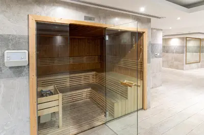 a walk in shower with a glass door in a room at Spacious Studio I Close to Dubai Canal in Dubai