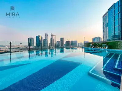 a swimming pool with a city skyline in the background at Mira Holiday Homes - Furnished 1 bedroom in Heart of Dubai in Dubai