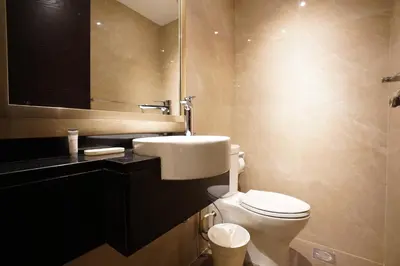 a bathroom with a toilet and a sink and a mirror at Mira Holiday Homes - Furnished 1 bedroom in Heart of Dubai in Dubai