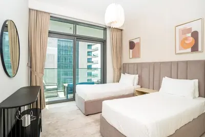 a hotel room with two beds and a window at HomesGetaway-Luxury 2Br Apartment in Beach Vista Tower 2 in Dubai