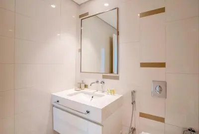 a white bathroom with a sink and a mirror at HomesGetaway-Luxury 2Br Apartment in Beach Vista Tower 2 in Dubai