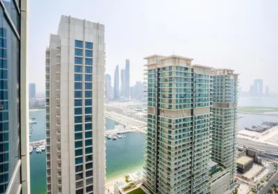 an aerial view of two tall buildings next to a river at HomesGetaway-Luxury 2Br Apartment in Beach Vista Tower 2 in Dubai