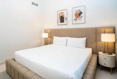 a bedroom with a large white bed and two lamps at HomesGetaway-Luxury 2Br Apartment in Beach Vista Tower 2 in Dubai