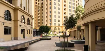 an empty street in a city with tall buildings at 360 Vacation - Spacious 3BR Close to the Beach I Rimal1 JBR in Dubai