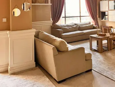 a living room with a couch and a chair at 360 Vacation - Spacious 3BR Close to the Beach I Rimal1 JBR in Dubai