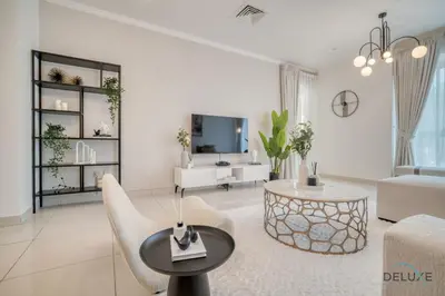 a living room with a couch and a table at Harmonious 1BR at Al Shera Tower JLT by Deluxe Holiday Homes in Dubai