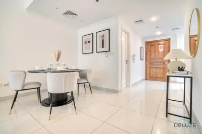 a dining room with a table and chairs at Harmonious 1BR at Al Shera Tower JLT by Deluxe Holiday Homes in Dubai