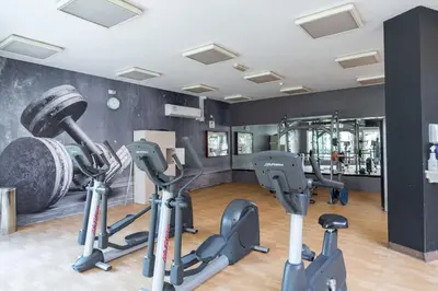 a gym with several exercise bikes in a room at Vogue The Greens Al Sidir near Mall of The Emirates, Three Bedroom Apartment with Balcony and full access to all amenities in Dubai