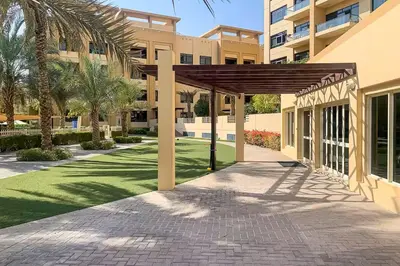 a pavilion in front of a building with palm trees at Vogue The Greens Al Sidir near Mall of The Emirates, Three Bedroom Apartment with Balcony and full access to all amenities in Dubai