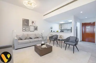 a living room with a couch and chairs and a table at Vogue The Greens Al Sidir near Mall of The Emirates, Three Bedroom Apartment with Balcony and full access to all amenities in Dubai