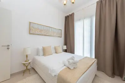 a white bedroom with a white teddy bear on a bed at BNew Chic 1BR Apt Near Trump Golf w Pool and Gym in Dubai