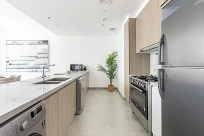 a kitchen with a sink and a refrigerator at Frank Porter - Stella Maris in Dubai