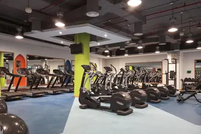 a gym with a bunch of tread machines in it at Frank Porter - Rimal 1 in Dubai