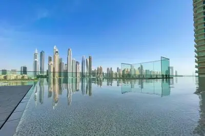 a view of a city skyline from a pool of water at Private Beachfront 1 Bed With 180 view of Marina Skyline in Dubai