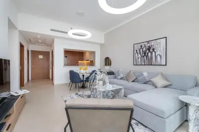 a living room with a couch and a table at Vogue Emirates Hills, Vida The Hills Residence near Marina and JBR, One Bedroom Apartment with Balcony, Golf Club and City Skyline View, Access to all Amenities in Dubai