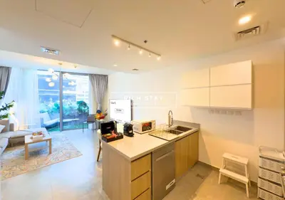 a kitchen and living room with a counter top at Unique 1BR in Stella Maris,City View,Dubai Marina in Dubai