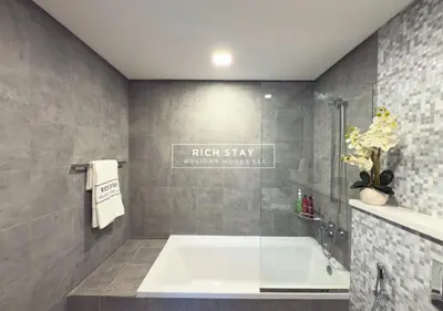 a bathroom with a bath tub and a sink at Unique 1BR in Stella Maris,City View,Dubai Marina in Dubai