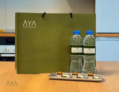 two bottles of water in a green bag on a table at Elegant Palm Jumeirah Retreat with Breathtaking Sea Views By AYA Boutique in Dubai