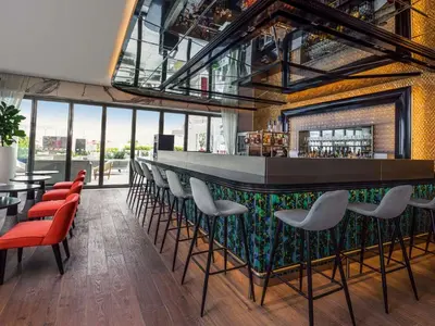 a bar in a building with red and white chairs at Elegant Palm Jumeirah Retreat with Breathtaking Sea Views By AYA Boutique in Dubai