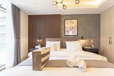 two beds in a hotel room with towels at Elegant Palm Jumeirah Retreat with Breathtaking Sea Views By AYA Boutique in Dubai
