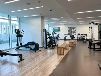 a gym with treadmills and cardio equipment in a building at Glamorous 3BR with Marina view in Dubai