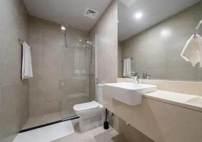 a bathroom with a toilet and a sink and a shower at 151 Residence Jumeirah Gardens in Dubai