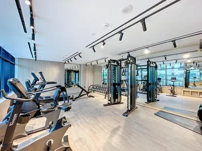 a gym with treadmills and elliptical machines at Vacationer l Bright Studio l Burj Khalifa View l Business Bay in Dubai