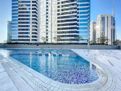 a swimming pool in a city with tall buildings at Vacationer l Bright Studio l Burj Khalifa View l Business Bay in Dubai