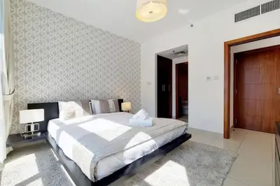 a bedroom with a bed and a wall at Standpoint A, Downtown - Contemporary One Bedroom in Dubai