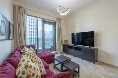 a living room with a purple couch and a large window at Vacationer I Sparkle T1 2 Bedroom I Marina Views I Steps away from Beach I Gym, Pool, Parking & Wi-Fi in Dubai
