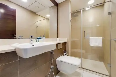 a bathroom with a sink and a shower and a toilet at Vacationer I Sparkle T1 2 Bedroom I Marina Views I Steps away from Beach I Gym, Pool, Parking & Wi-Fi in Dubai