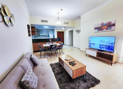 a living room with a couch and a flat screen tv at RH- Unwind and Relax, 1BR, Burj View from balcony, Downtown in Dubai