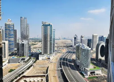 a view of a city with tall buildings and train tracks at RH- Unwind and Relax, 1BR, Burj View from balcony, Downtown in Dubai