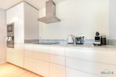 a kitchen with white cabinets and a stainless steel appliance at Alluring 2BR at Al Majara 1 Dubai Marina by Deluxe Holiday Homes in Dubai
