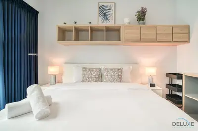 a bedroom with a large white bed and two lamps at Alluring 2BR at Al Majara 1 Dubai Marina by Deluxe Holiday Homes in Dubai