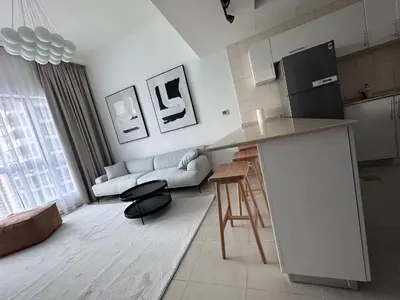 a kitchen and living room with a couch and a table at Bay Central- Marina Dubai, One bed room Apartment in Dubai