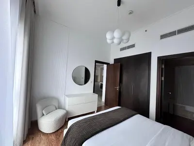 a bedroom with a bed and a chair and a mirror at Bay Central- Marina Dubai, One bed room Apartment in Dubai