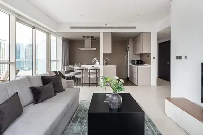 a living room with a couch and a table at Frank Porter - West Avenue in Dubai