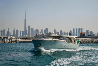 a boat in the water with a city in the background at Yacht Experience - Stella Romana in Dubai