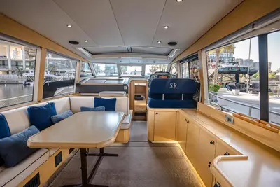 a dining area of a boat with a table and chairs at Yacht Experience - Stella Romana in Dubai