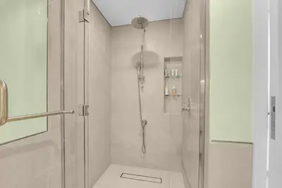 a bathroom with a shower with a glass door at Stylish 1 Bedroom Apartment Near Burj Al Arab (Madinat Jumeirah) in Dubai