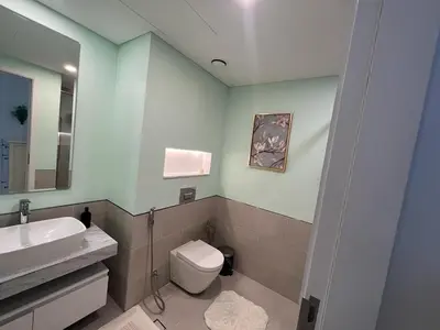 a bathroom with a white toilet and a sink at Stylish 1 Bedroom Apartment Near Burj Al Arab (Madinat Jumeirah) in Dubai