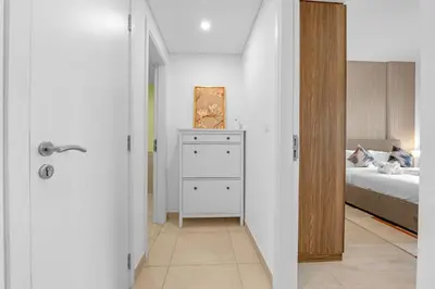 a bedroom with a bed and a white dresser at Stylish 1 Bedroom Apartment Near Burj Al Arab (Madinat Jumeirah) in Dubai