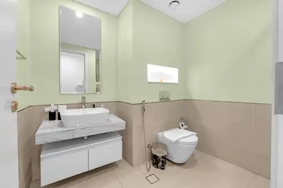 a bathroom with a sink and a toilet and a mirror at Stylish 1 Bedroom Apartment Near Burj Al Arab (Madinat Jumeirah) in Dubai