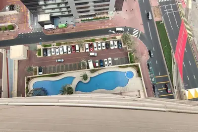 an aerial view of a building with a swimming pool at Holiday Home near beach & metro in Dubai