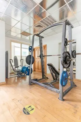 a gym with several exercise equipment in a room at Holiday Home near beach & metro in Dubai