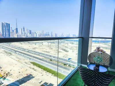 a person sitting in a chair in a building looking out at a city at STAY BY LATINEM Luxury 2BR Holiday Home CV B2302 near Burj Khalifa in Dubai