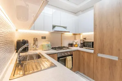 a kitchen with a sink and a stove at Superb Amenities - 1BR in Resortz by Danube,Arjan - Allsopp&Allsopp in Dubai